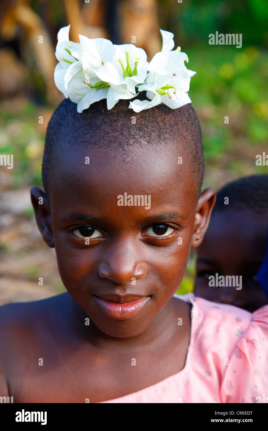 Girl, 10 years, with flowers on her head, Kamachumu, Kagera region, Tanzania, Africa Stock Photo