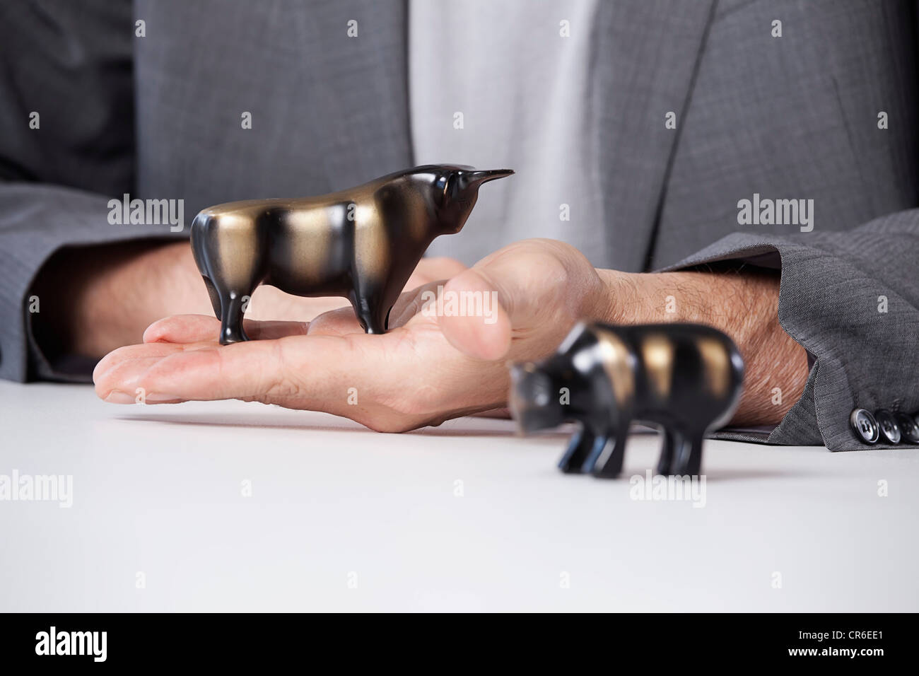 Germany, Bavaria, Munich, Mature man with bull and bear figurines Stock Photo