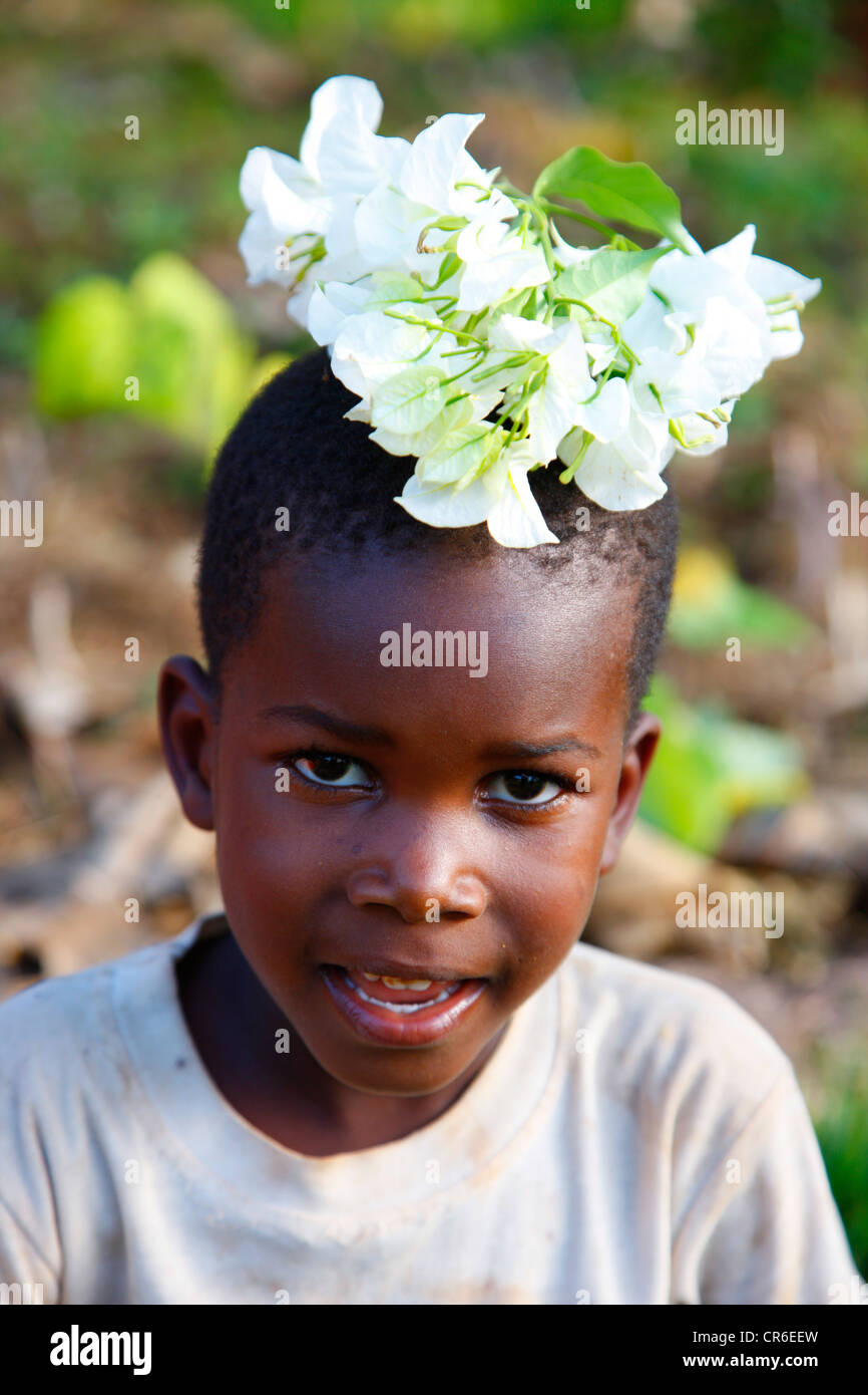 Boy, 6 years, with flowers on his head, Kamachumu, Kagera region, Tanzania, Africa Stock Photo