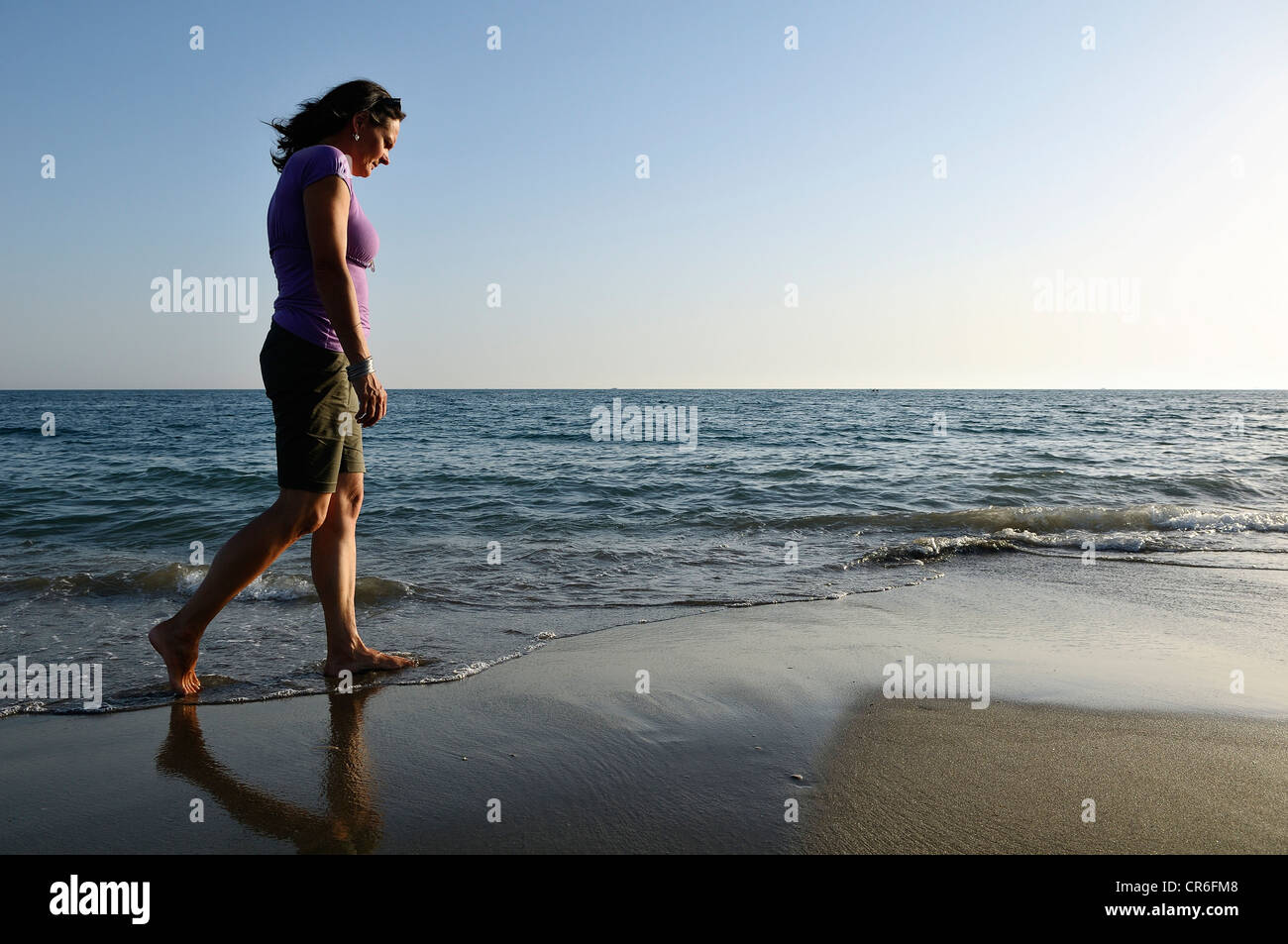 Woman walking on the beach, Lido di Ostia, Rome, Lazio region, Italy, Europe Stock Photo