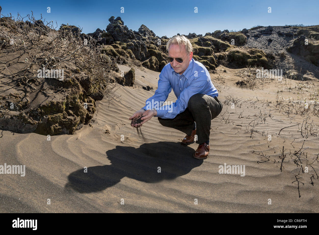 Scientist investigating ash from past volcanic eruptions, South Coast, Iceland Stock Photo
