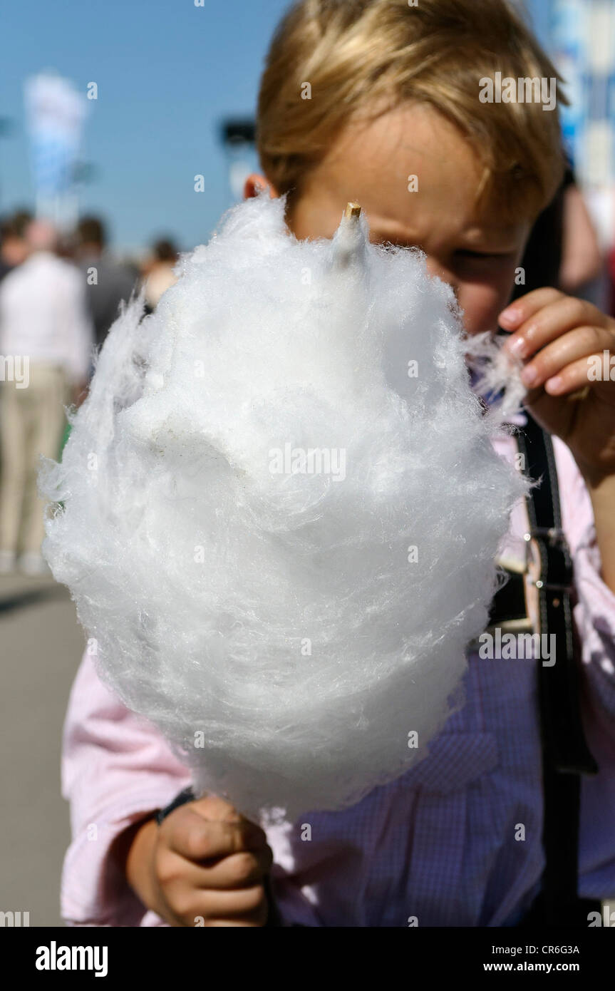 5-year old boy eating candy floss, Oktoberfest 2010, Munich, Upper Bavaria, Bavaria, Germany, Europe Stock Photo