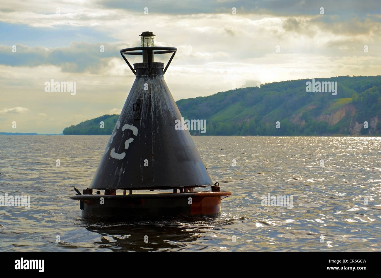 Old black beacon buoy on the Volga river. Stock Photo