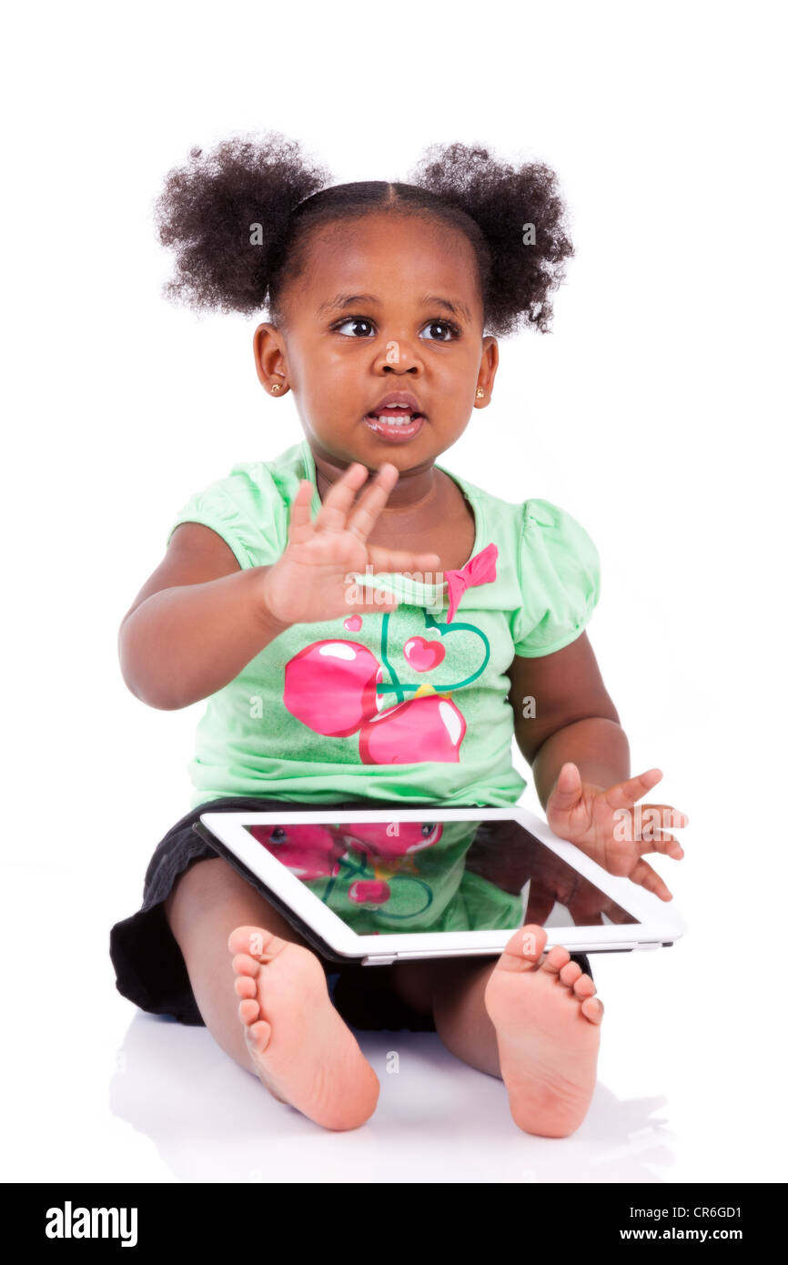 Little african american girl using a tablet pc, isolated on white ...