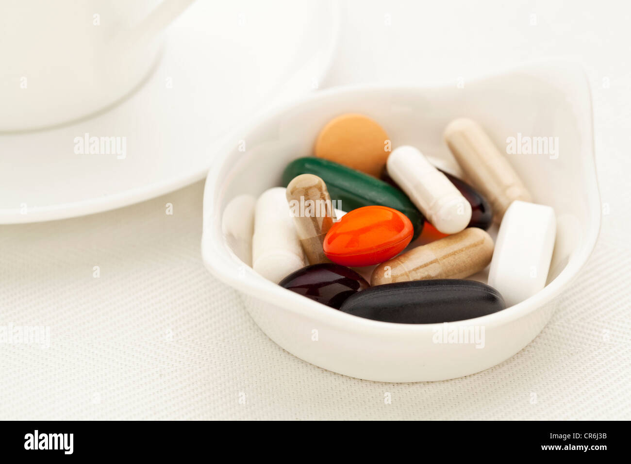 bowl of vitamin, supplement and medicine pills - breakfast concept - shallow depth of field Stock Photo