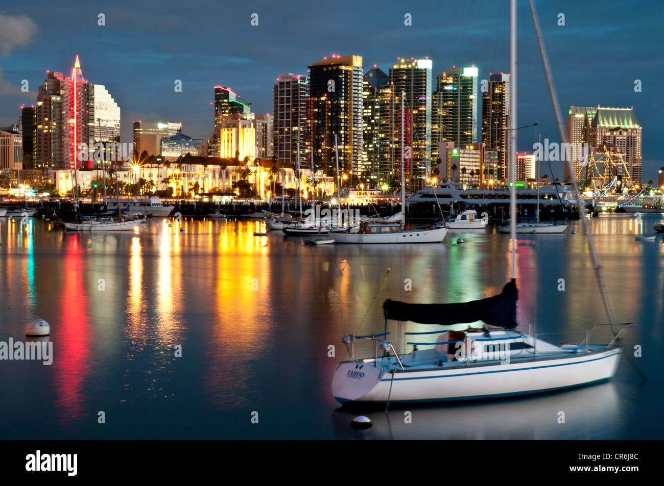 San Diego city lights reflected on water with sailboats in foreground Stock Photo