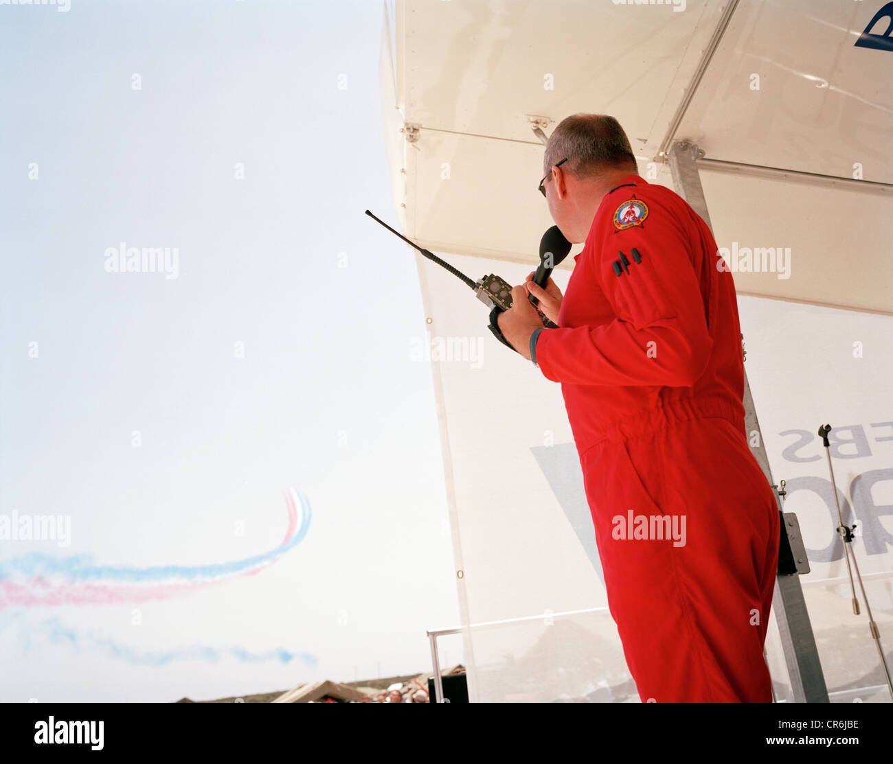 Ground commentator pilot of the Red Arrows, Britain's RAF aerobatic team broadcasts the 30-min display during airshow. Stock Photo