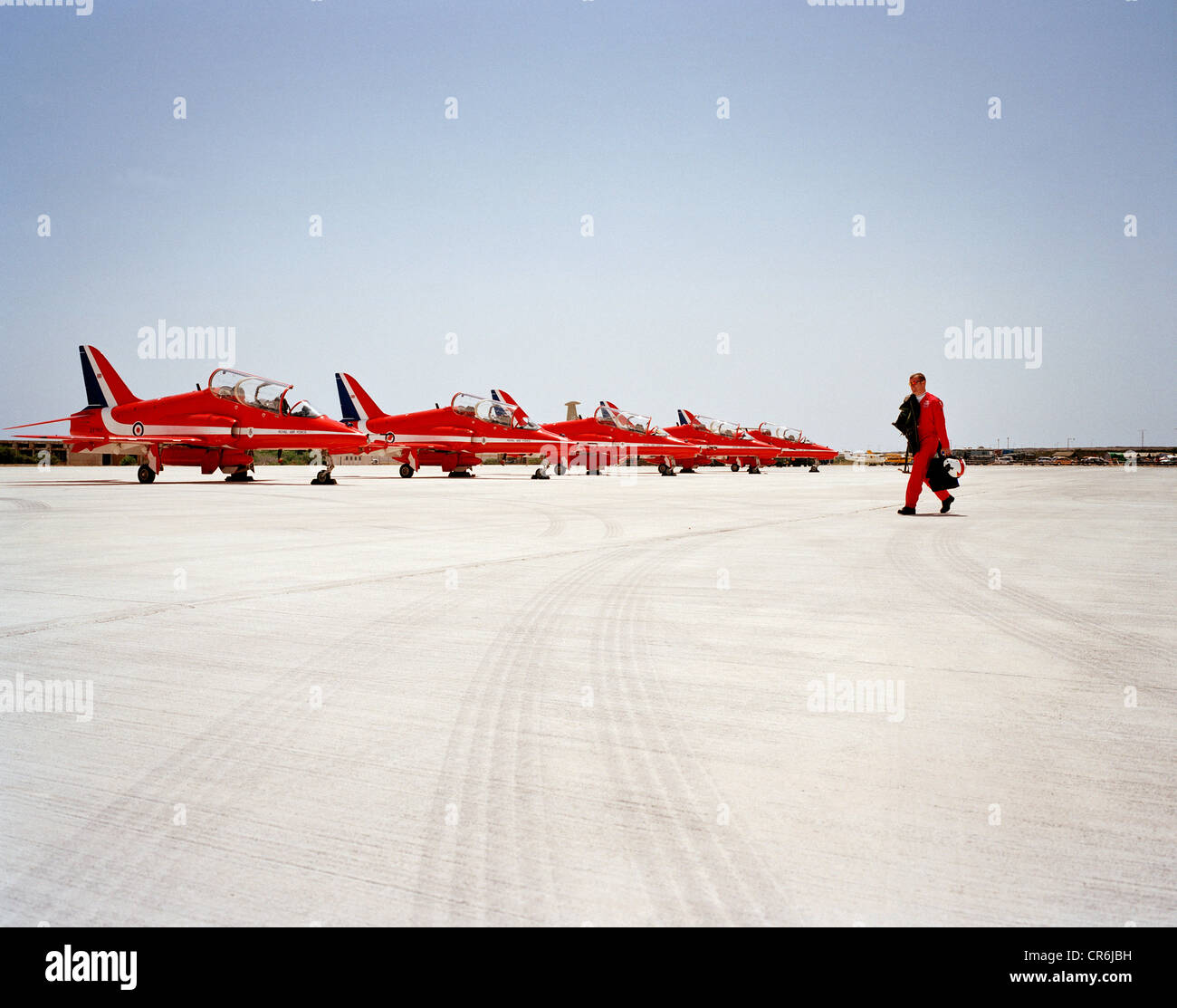 Single pilot of the Red Arrows, Britain's RAF aerobatic team walks out to his Hawk aircraft before a display flight to Jordan. Stock Photo