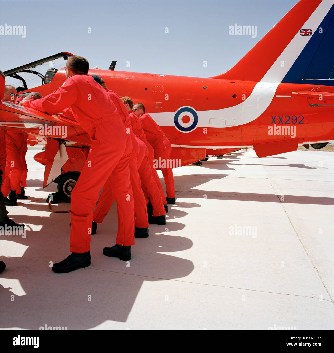 Pilots of the Red Arrows, Britain's RAF aerobatic team during pre-display briefing on a Hawk wing before an airshow. Stock Photo