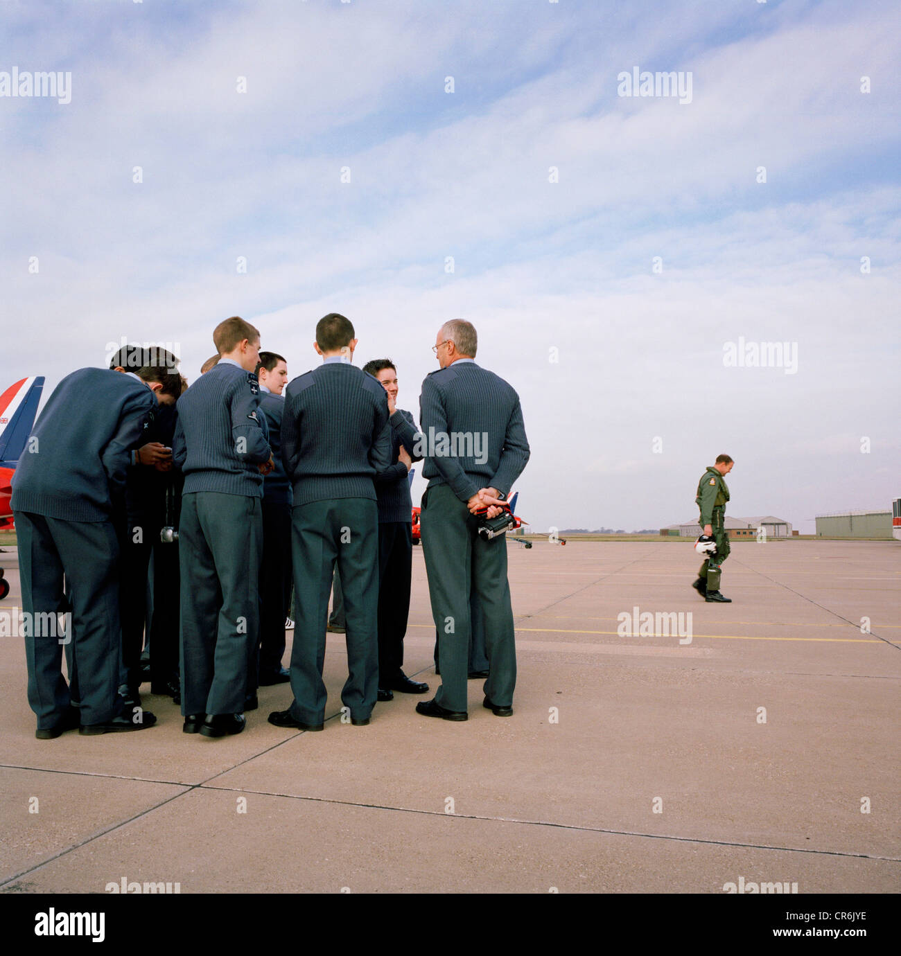 Young air cadets watch returning pilot of the Red Arrows, Britain's RAF aerobatic team during visit to RAF Scampton. Stock Photo