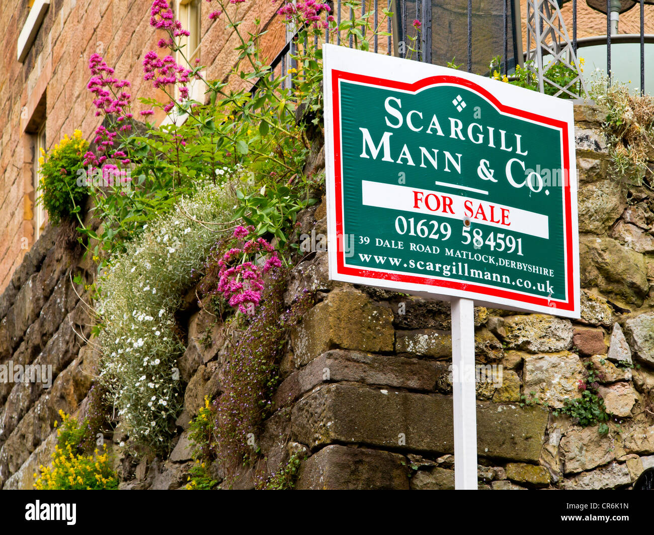 For Sale Sign Outside A Country Cottage In Matlock Bath Village In