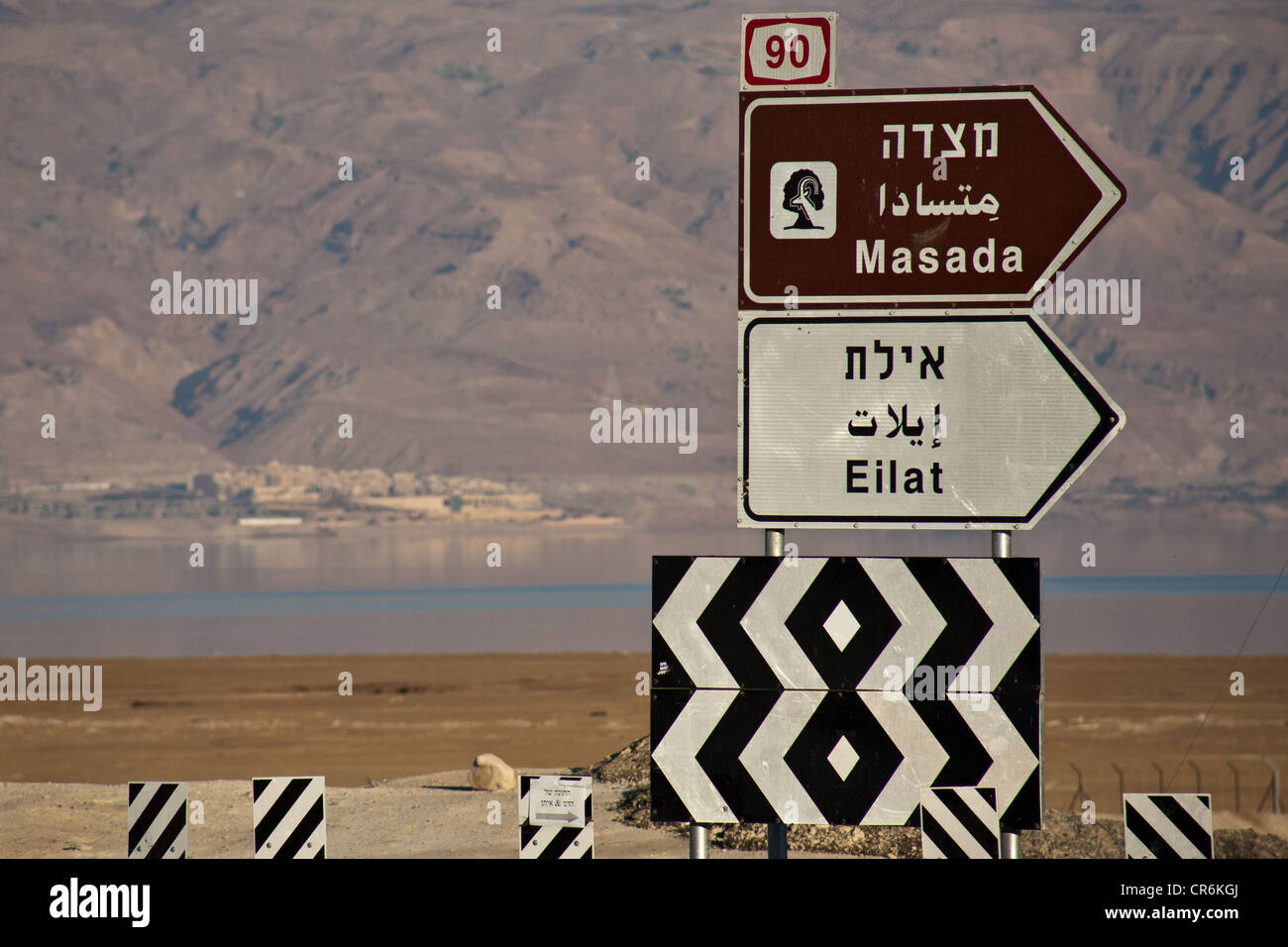 Road 90 direction sign for Masada and Eilat on shores of the Dead Sea ...
