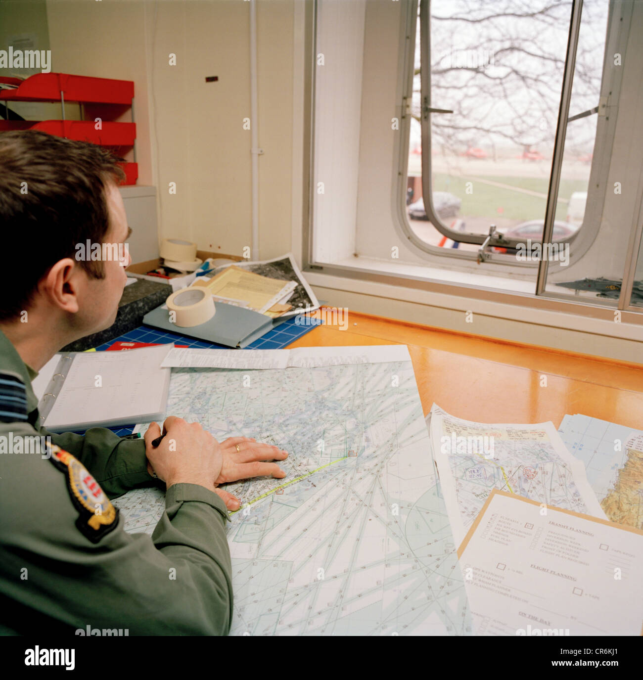 Pilot of the Red Arrows, Britain's RAF aerobatic team with flight planning duties gazes for a moment out of the window. Stock Photo