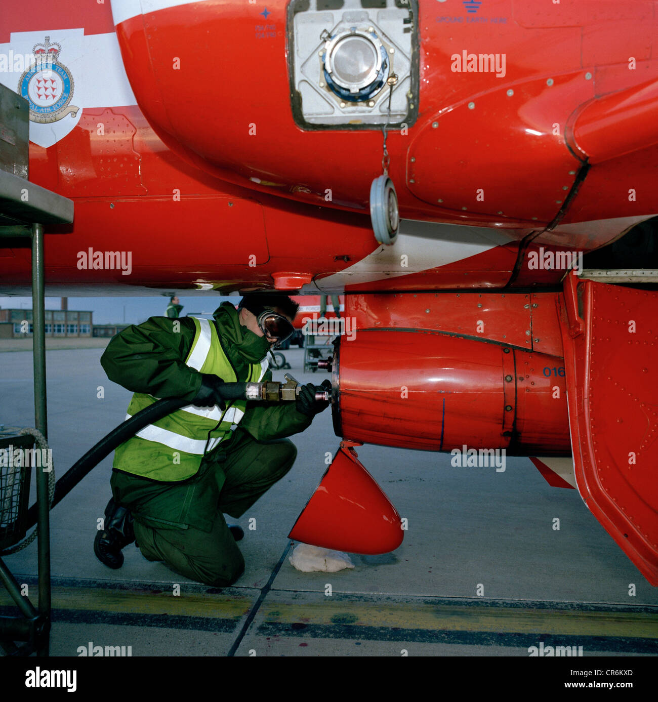 A dye team engineer refills the dye-derv mixture to Hawk jet's the smoke pod of the Red Arrows, Britain's RAF aerobatic team. Stock Photo