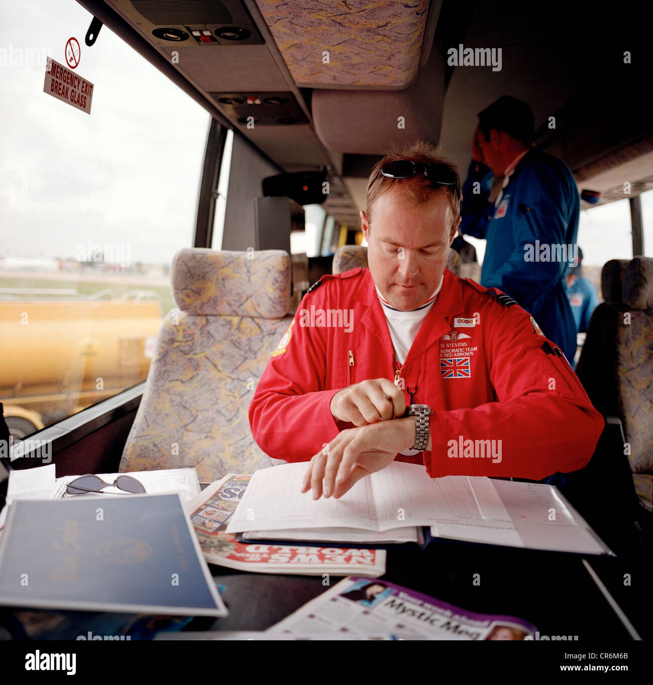 Pilot of the Red Arrows, Britain's RAF aerobatic team checks timings of forthcoming airshow display in team coach. Stock Photo