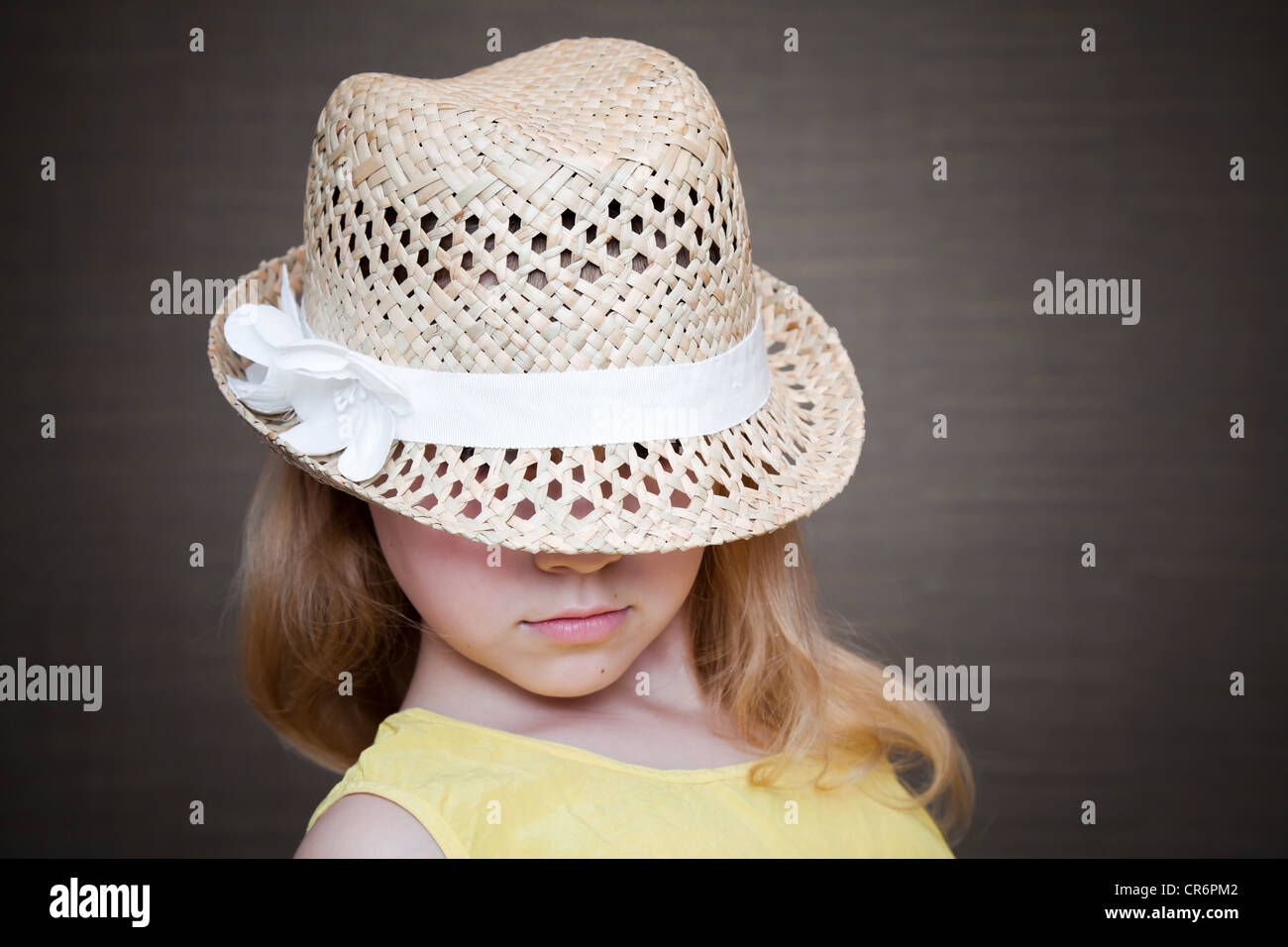 Little blond girl wearing straw hat Stock Photo