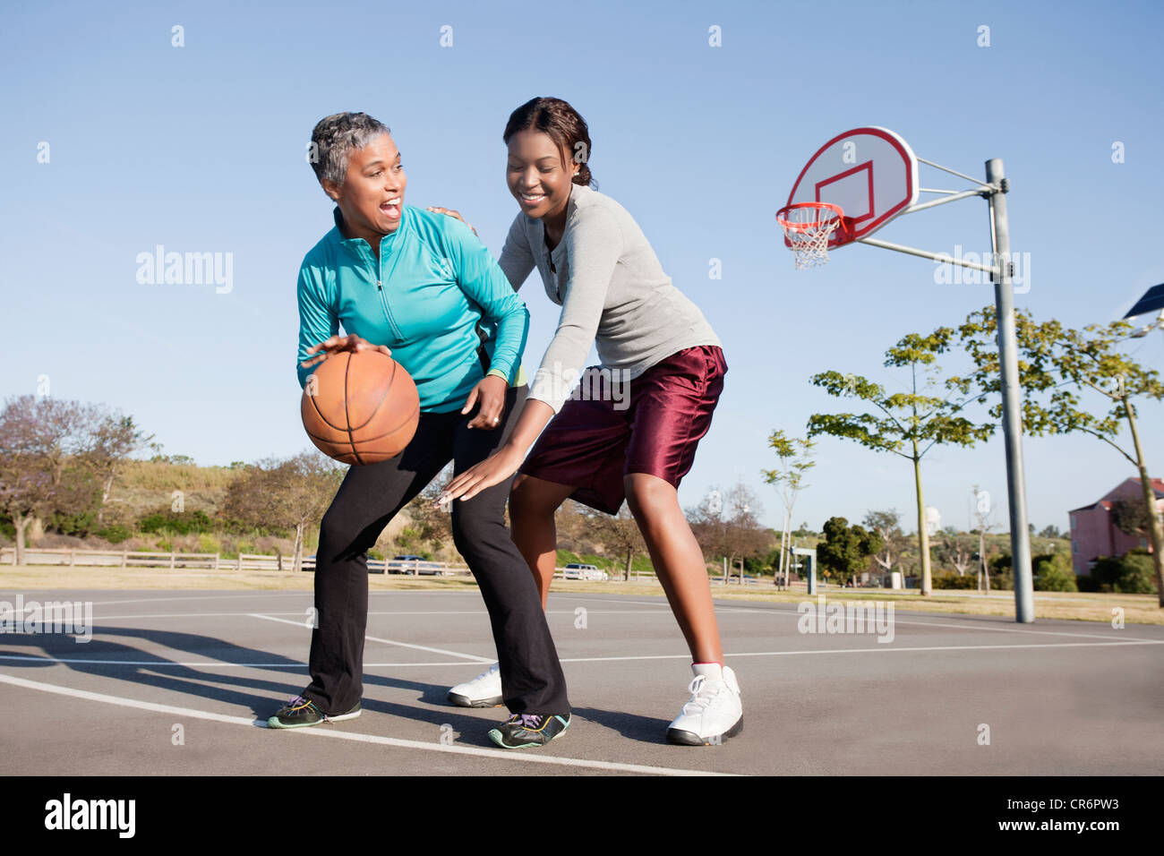 Mother and daughter playing basketball Stock Photo Alamy