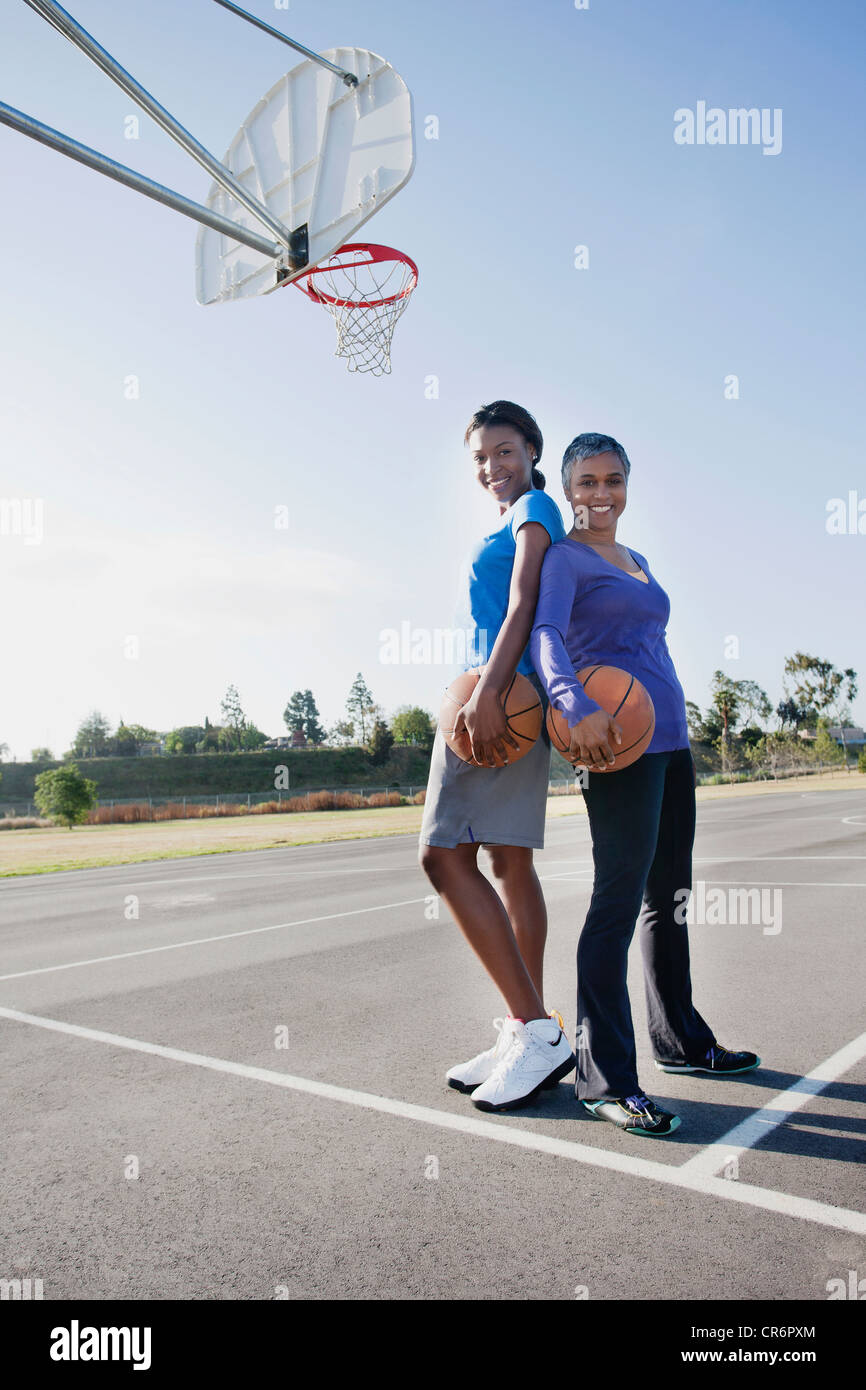 Mother and daughter playing basketball Stock Photo Alamy