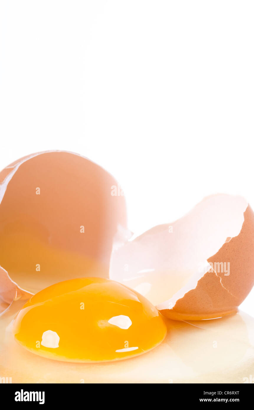 a raw egg broken on white background Stock Photo