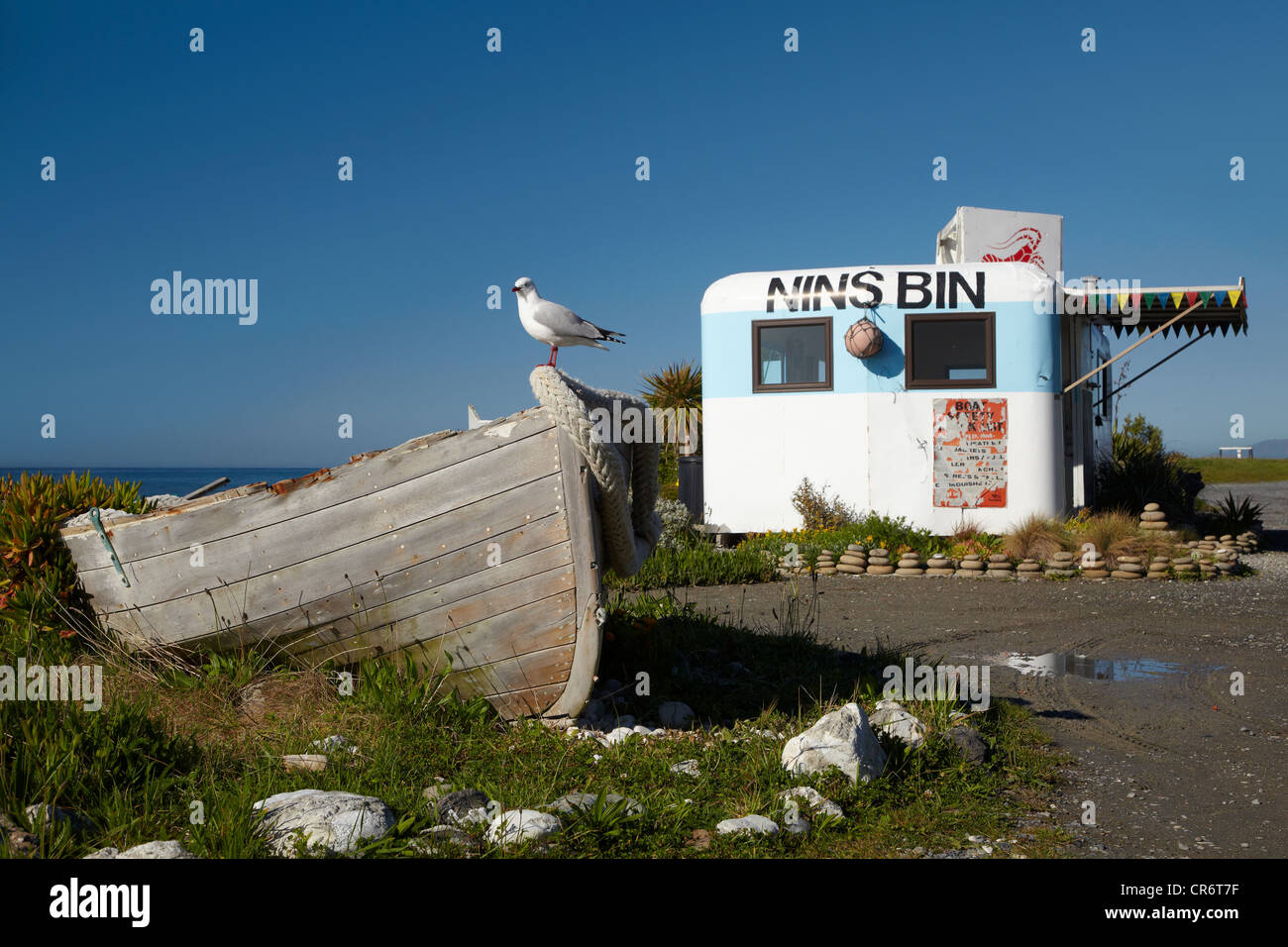 Wooden dinghy, and Nins Bin lobster caravan, Kaikoura Coast