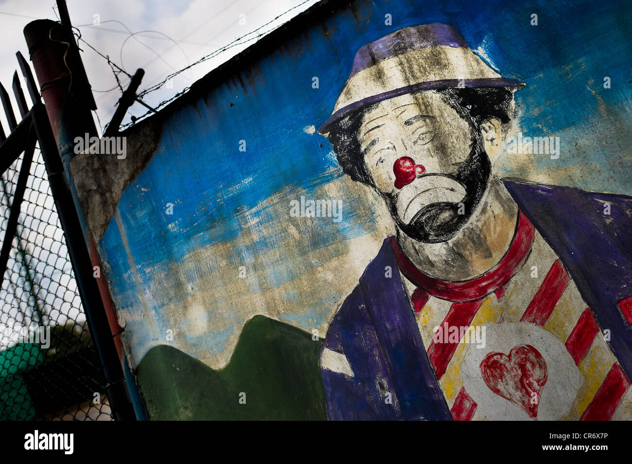 A painted artwork, depicting a vagabond clown, appears on the wall close to the circus school Circo para Todos, Cali, Colombia. Stock Photo