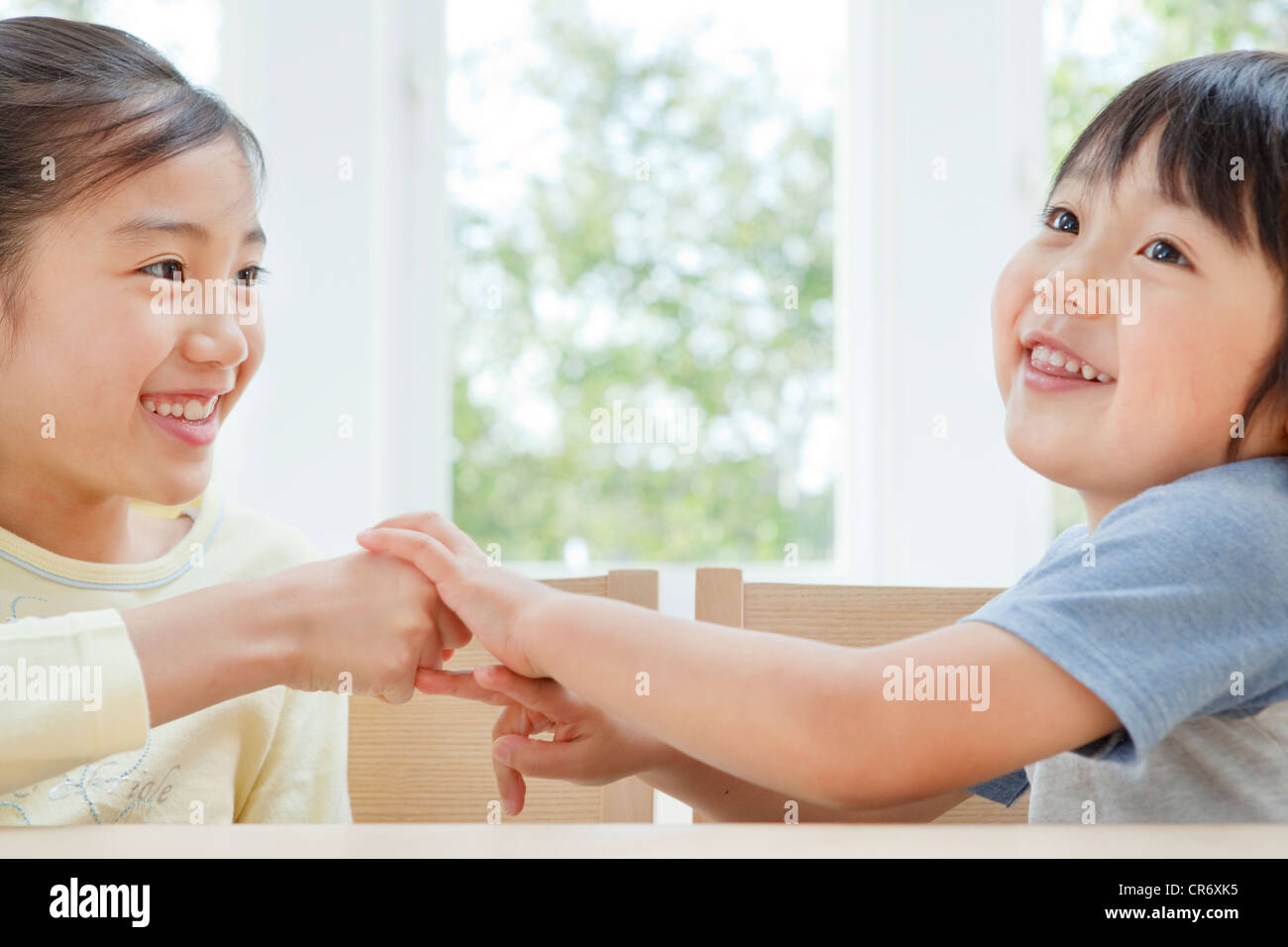 Brother and sister playing rockpaperscissors Stock Photo Alamy