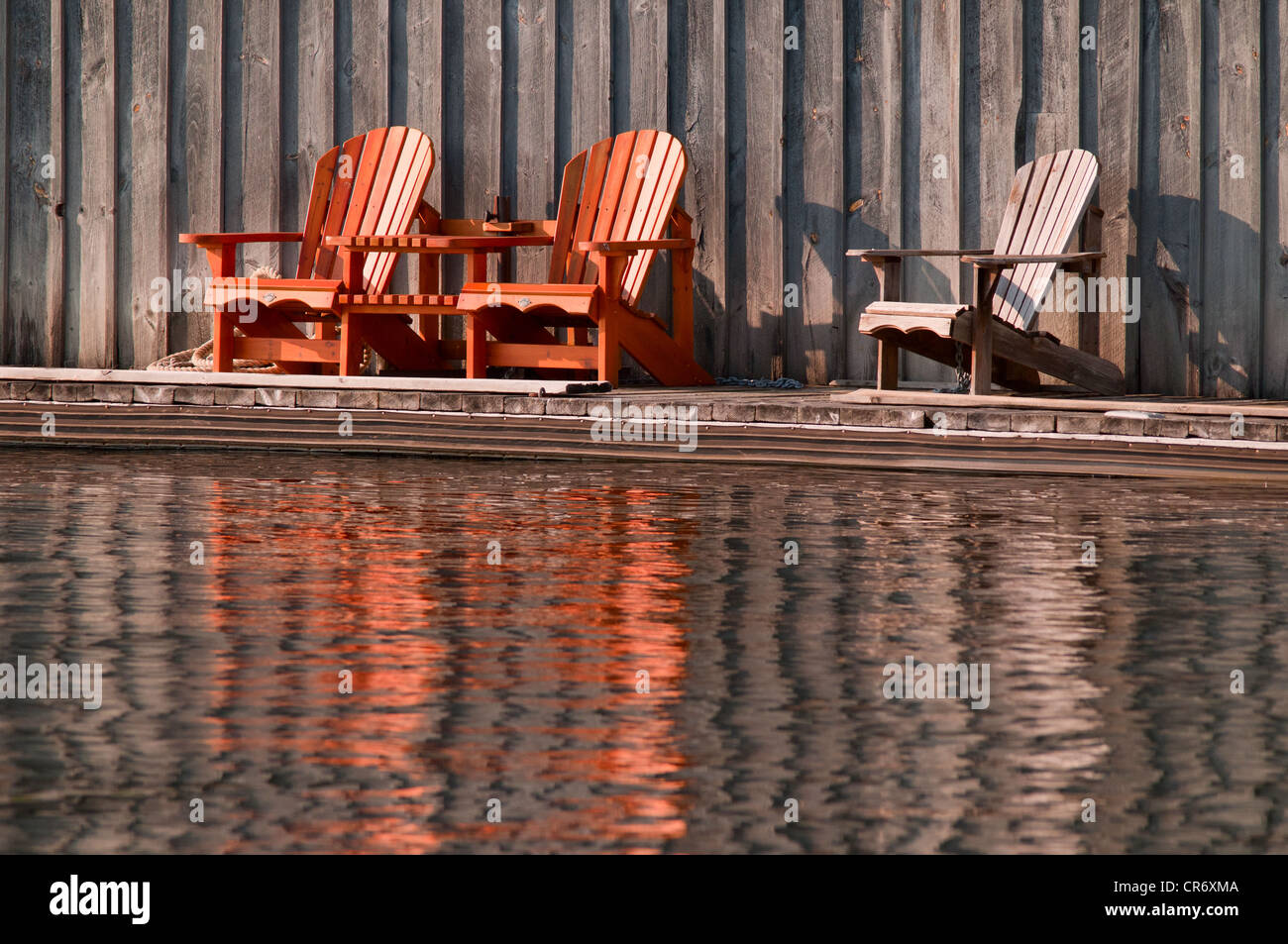 Wooden chairs on a dock Stock Photo - Alamy
