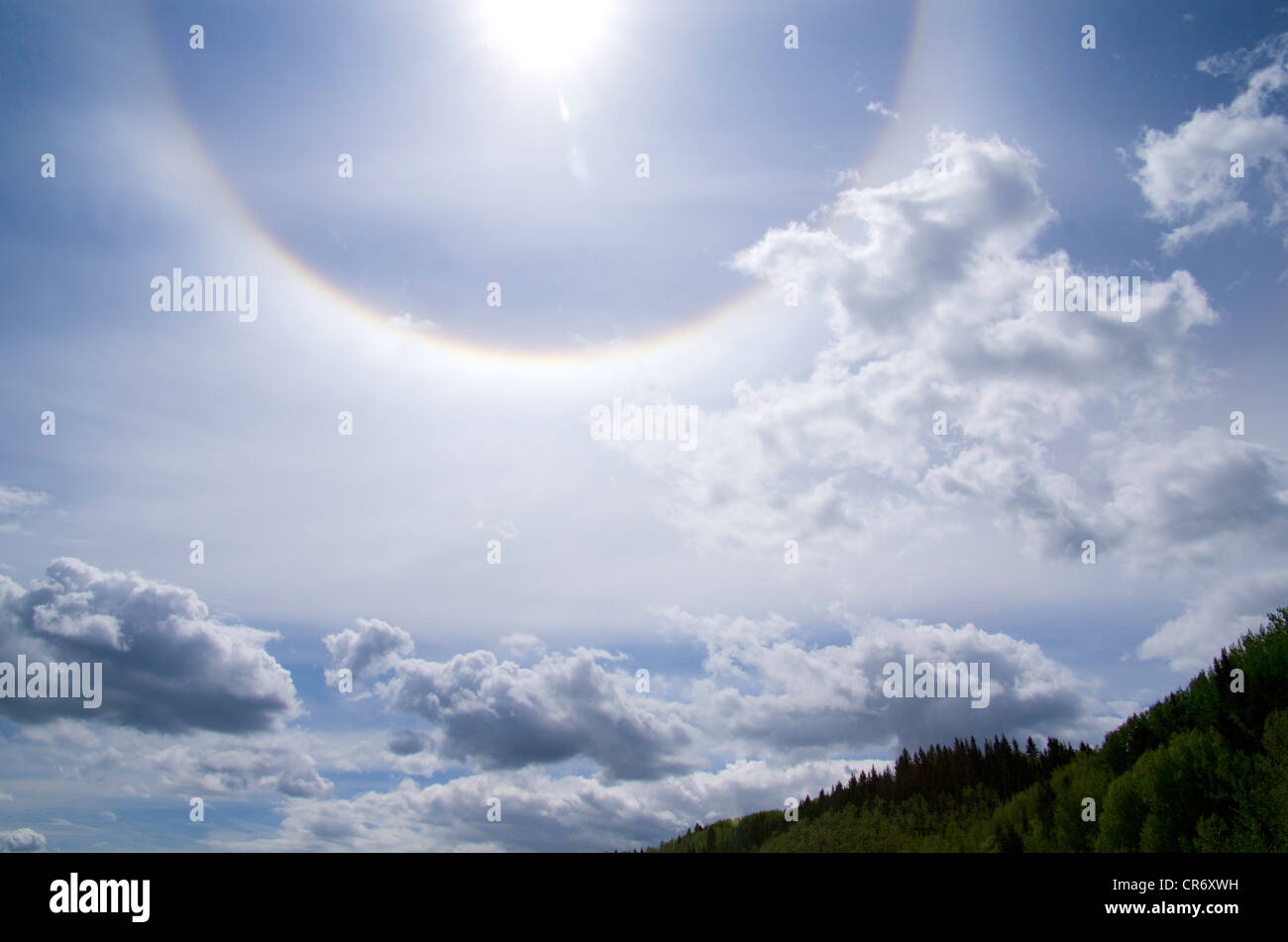 A sun dog, or parhelion, which is an atmospheric phenomenon that appears as a halo around the run. Stock Photo