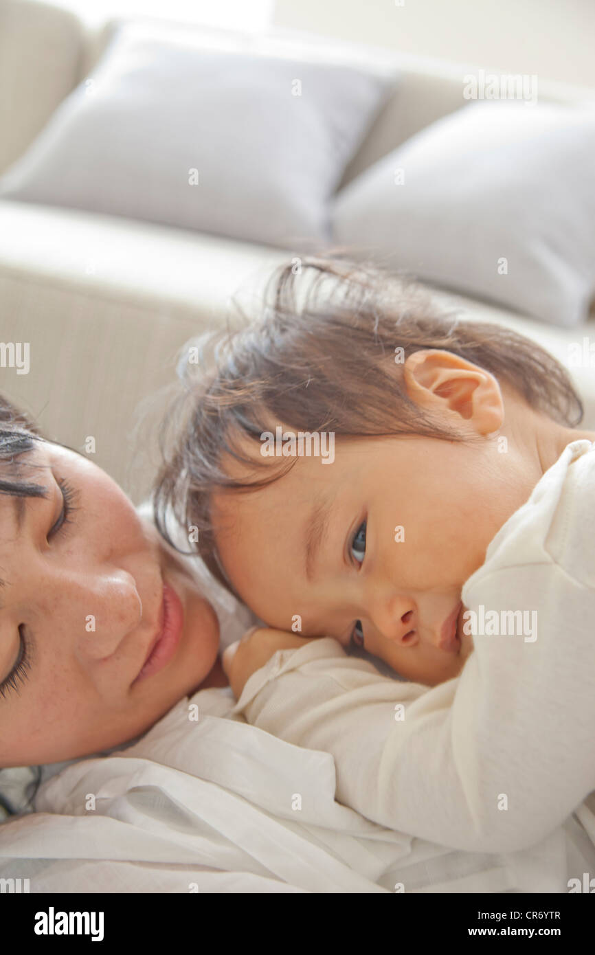 Baby son sleeping on mother's chest Stock Photo Alamy