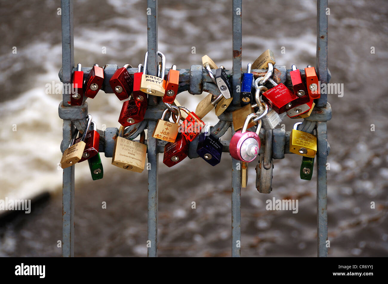 Colourful padlocks, love locks, on the railing of Brausebruecke bridge