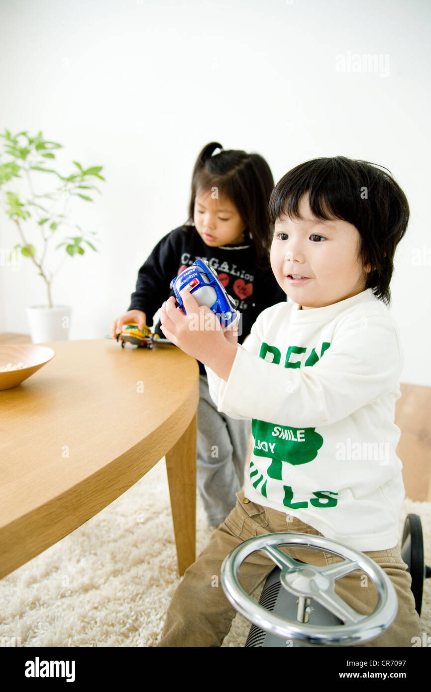 Two children playing with toys Stock Photo - Alamy