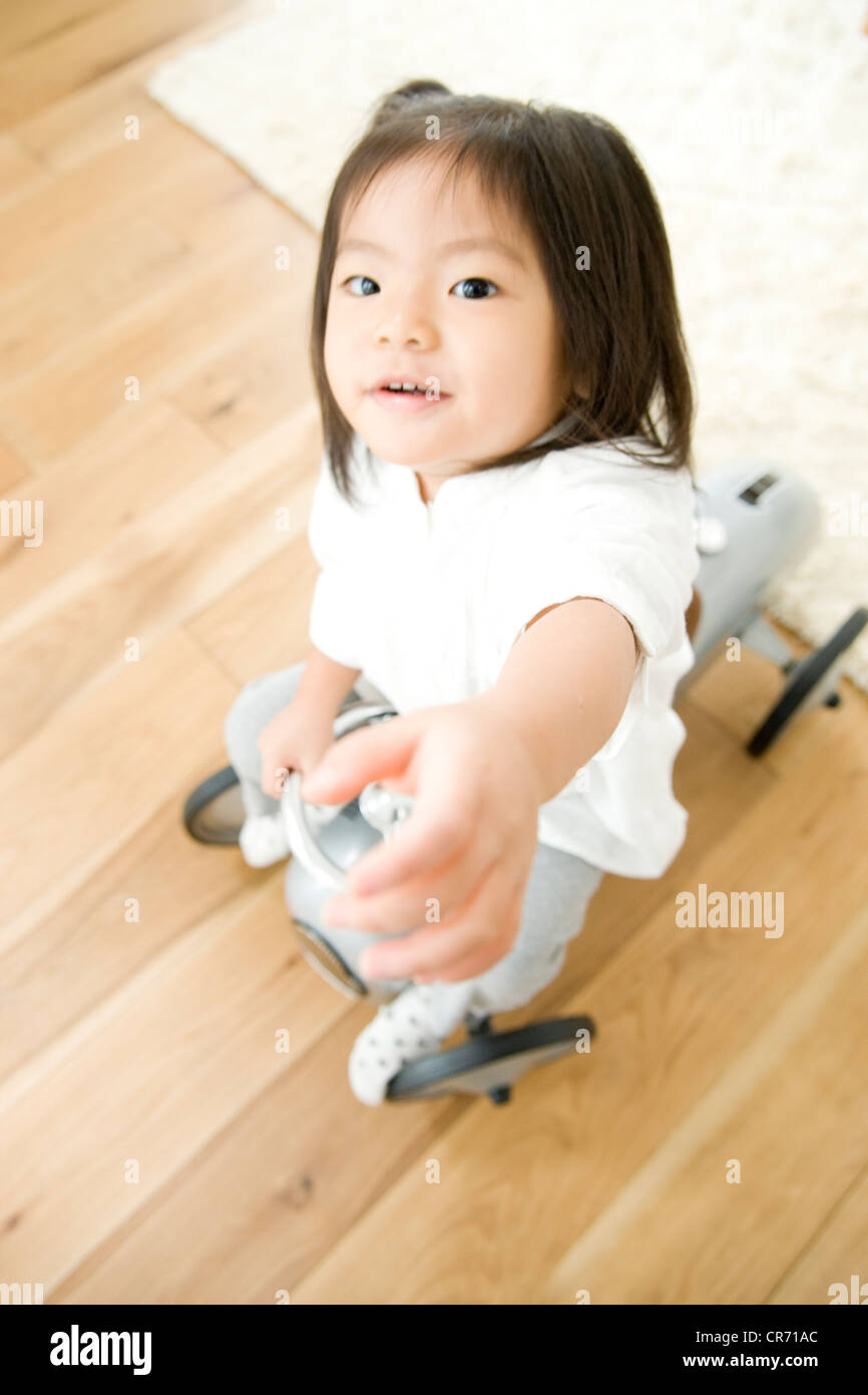Girl playing with toy car Stock Photo - Alamy