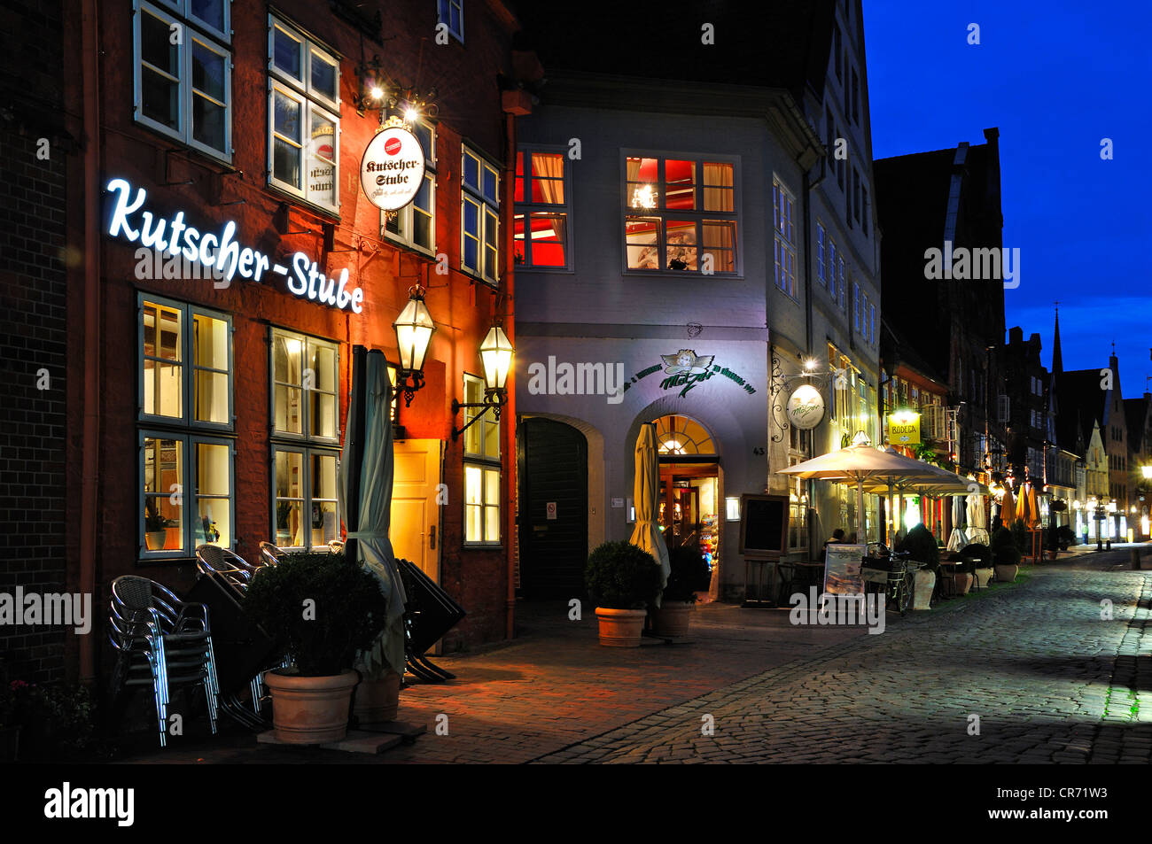 Street scene at night with cafes and restaurants, Heiliggeiststrasse, Lueneburg, Lower Saxony, Germany, Europe Stock Photo
