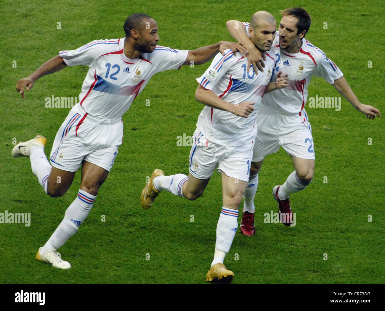 Zinedine Zidane (center), *23.7.1972, celebrates his 1-0 goal after penalty with his team mates Thierry Henry (left) and Frank Ribery during the France versus Italy 2006 FIFA World Cup final soccer match at the Olympic Stadium in Berlin, Germany, Sunday, 9.7.2006, Stock Photo