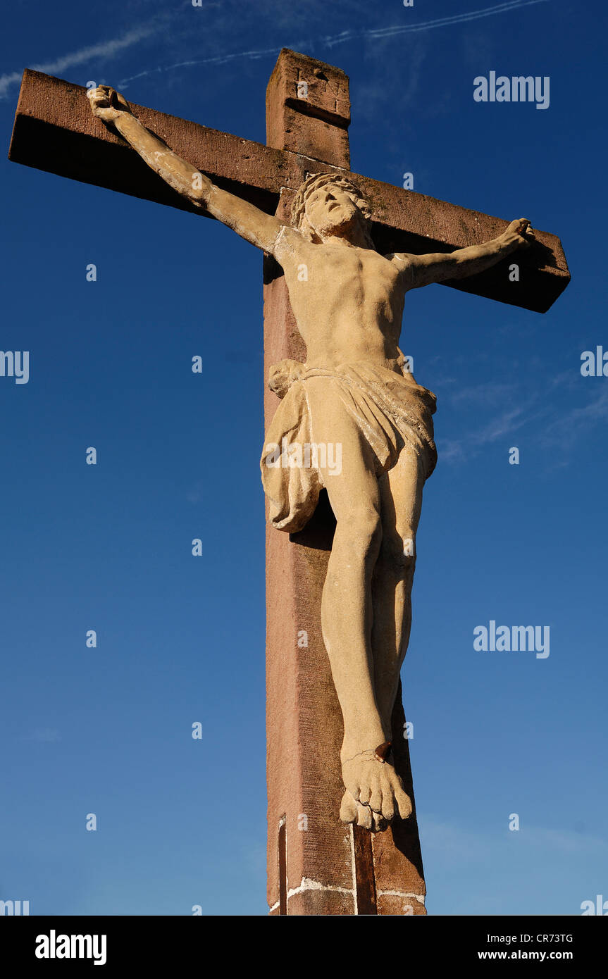 Stone crucifix, 19th Century, against a blue sky in the cemetery of Guebwiller, Route de Colmar, Guebwiller, Alsace, France Stock Photo