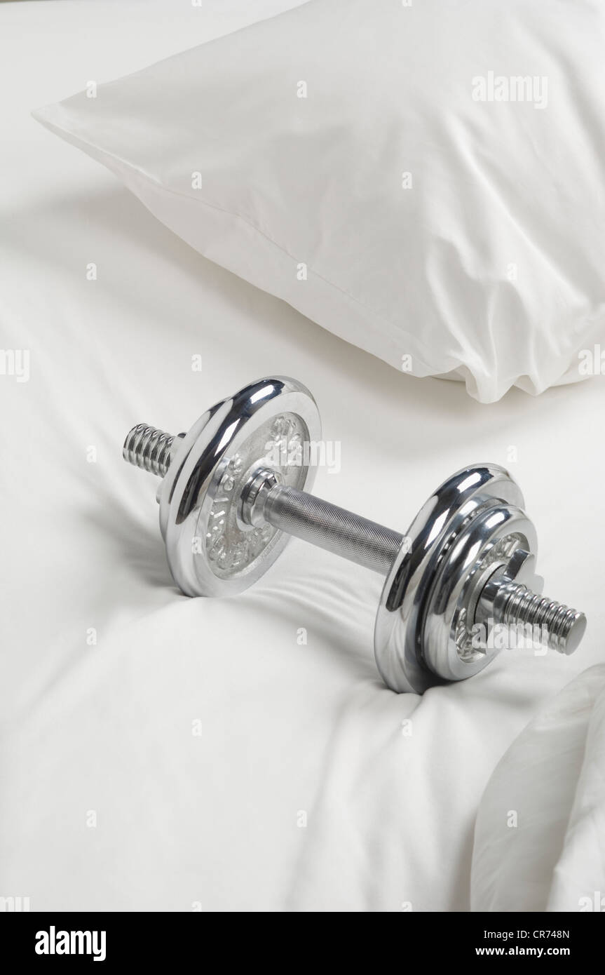 Dumbbell on bed, close up Stock Photo Alamy