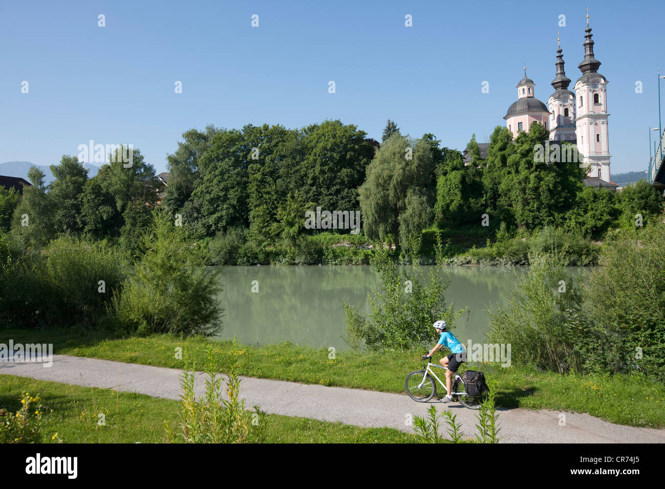 Austria, Carinthia, Villach, Mid adult woman riding bicycle Stock Photo