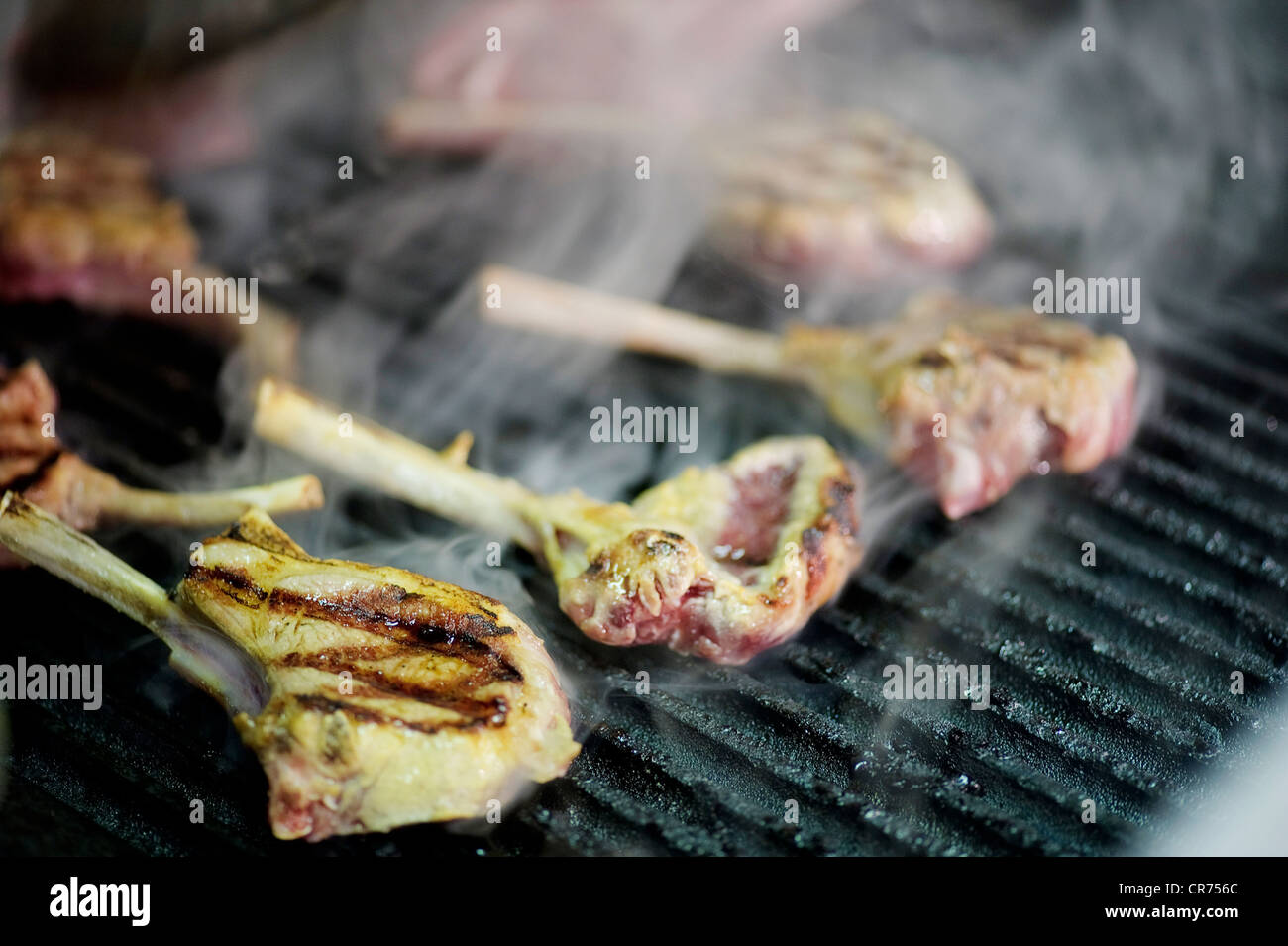 lamb chops cooking on barbecue grill with smoke Stock Photo Alamy