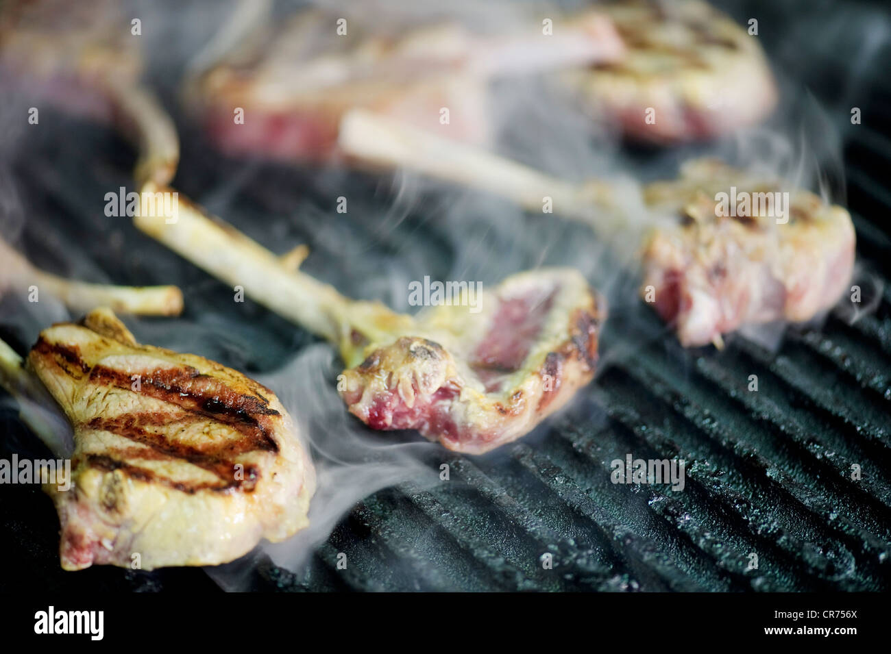 lamb chops cooking on barbecue grill with smoke BBQ Stock Photo Alamy