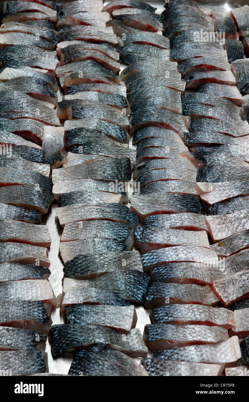 Sea bass, temperate bass (Moronidae) cut into pieces, finger food Stock Photo