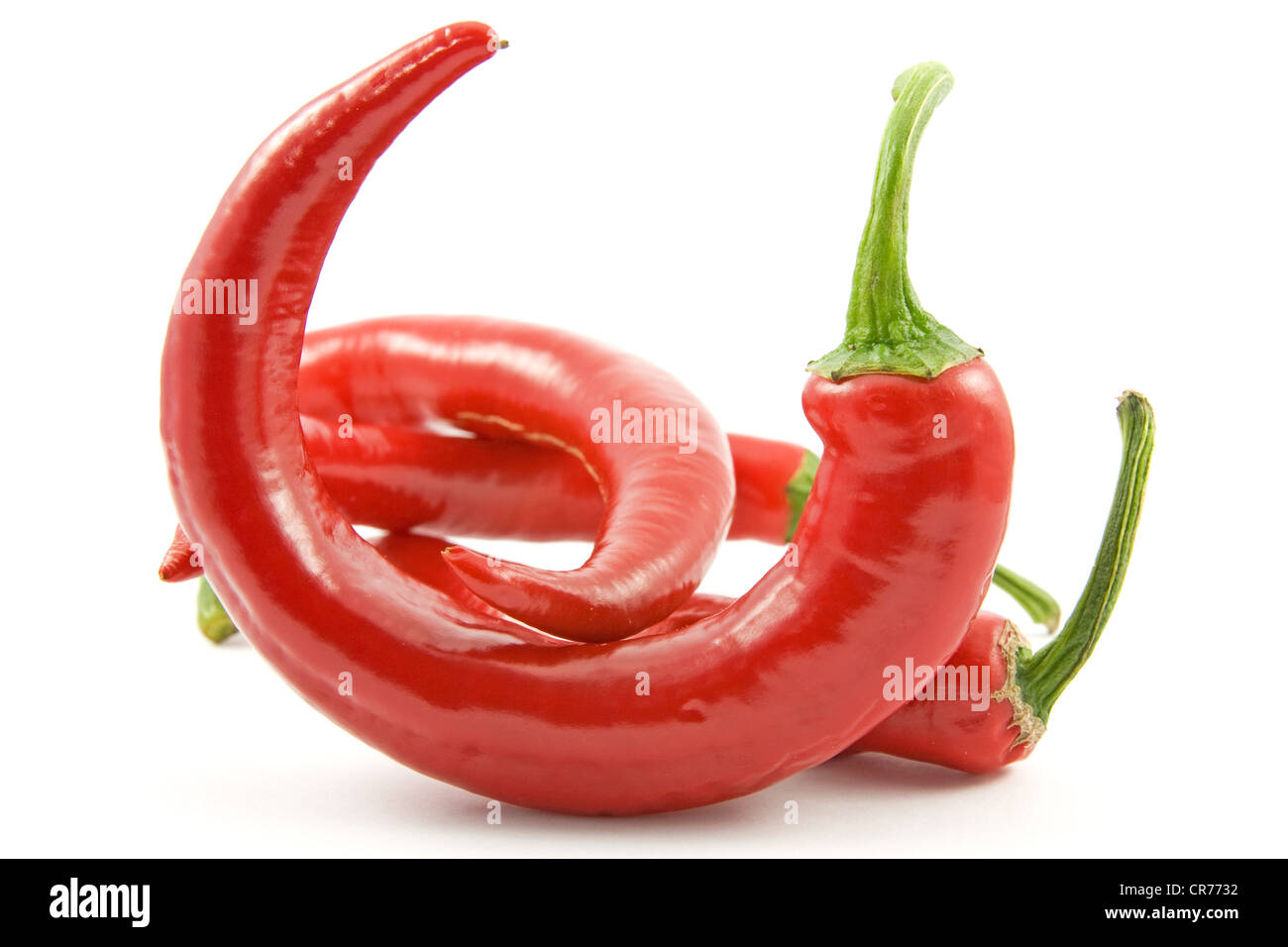 Red chili peppers over a white background Stock Photo - Alamy