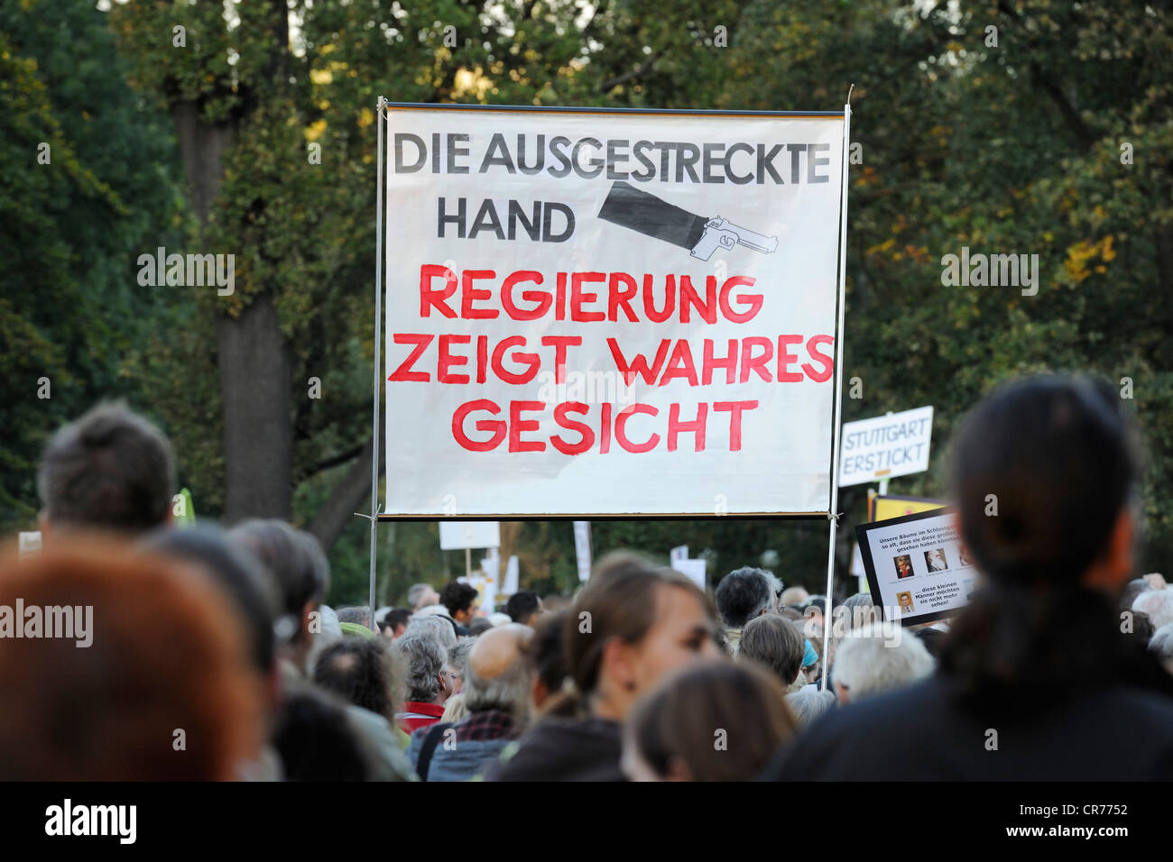 Protesters carrying a banner with 'Regierung zeigt wahres Gesicht', German for 'Government shows its true colours' in a Stock Photo