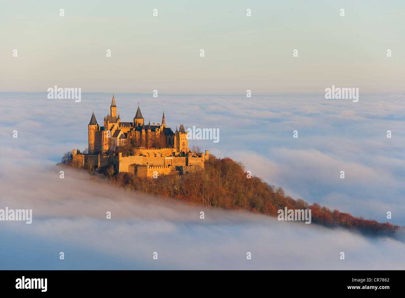 Burg Hohenzollern castle in morning light with autumn forest, morning mist, Schwaebische Alb, Swabian Alb, Baden-Wuerttemberg Stock Photo