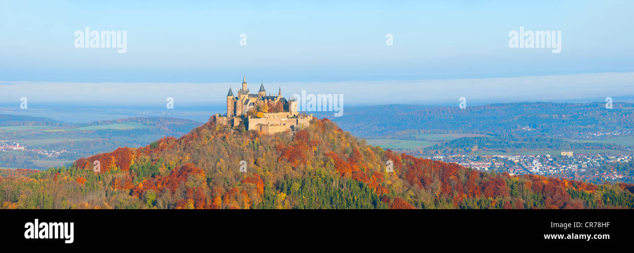Burg Hohenzollern Castle in the early morning light and fog, with autumnal forest, Swabian Alb, Baden-Wuerttemberg Stock Photo