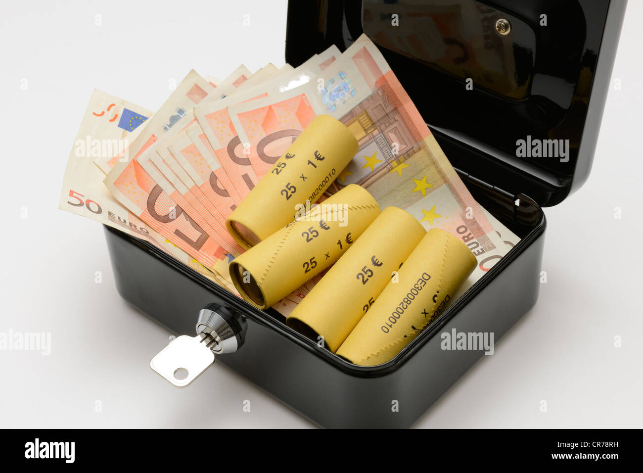 Euro banknotes and rolled up coins in a cash box Stock Photo