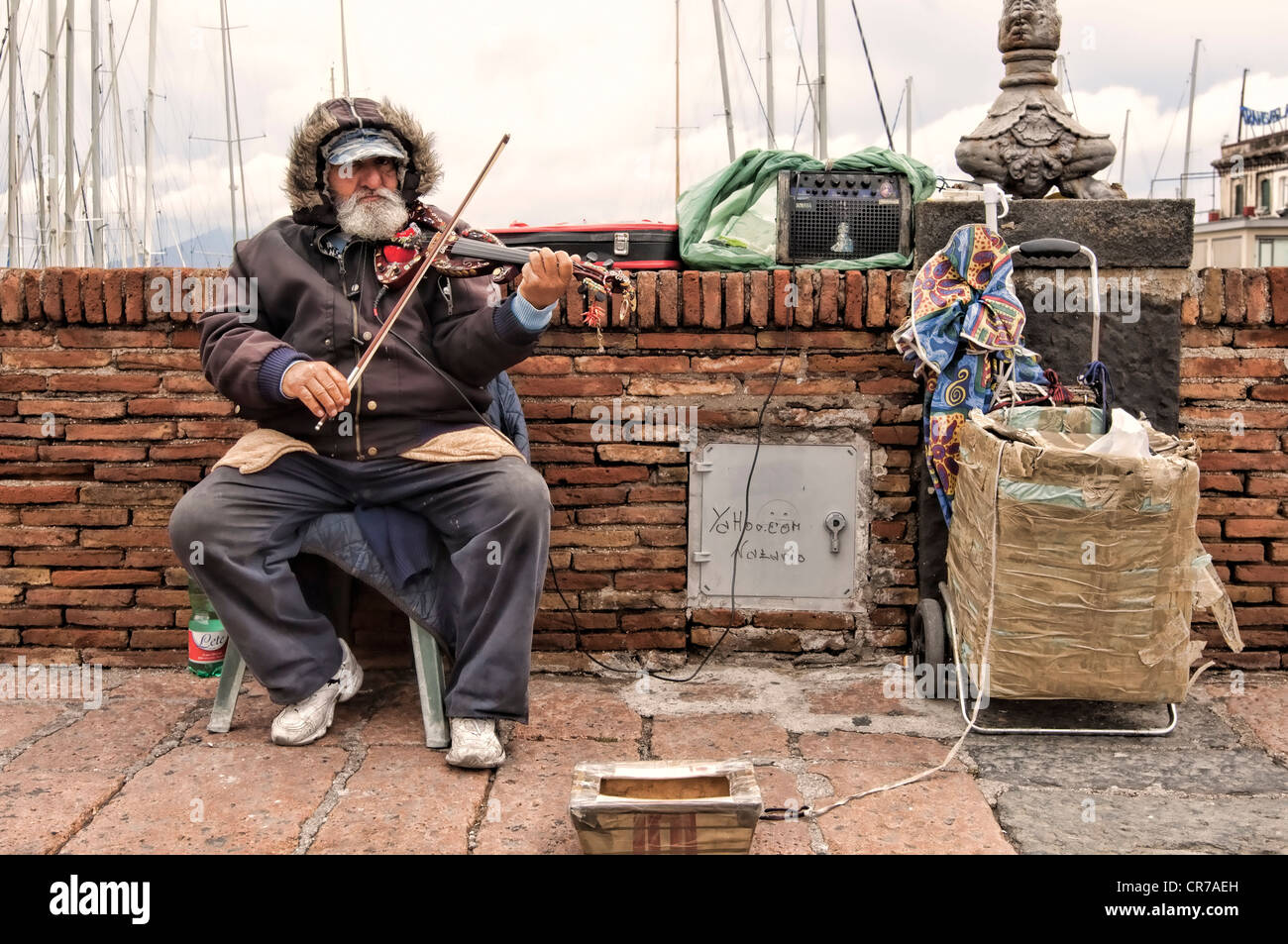 Elderly man (60+) busking with an electric Violin, Naples, Italy Stock