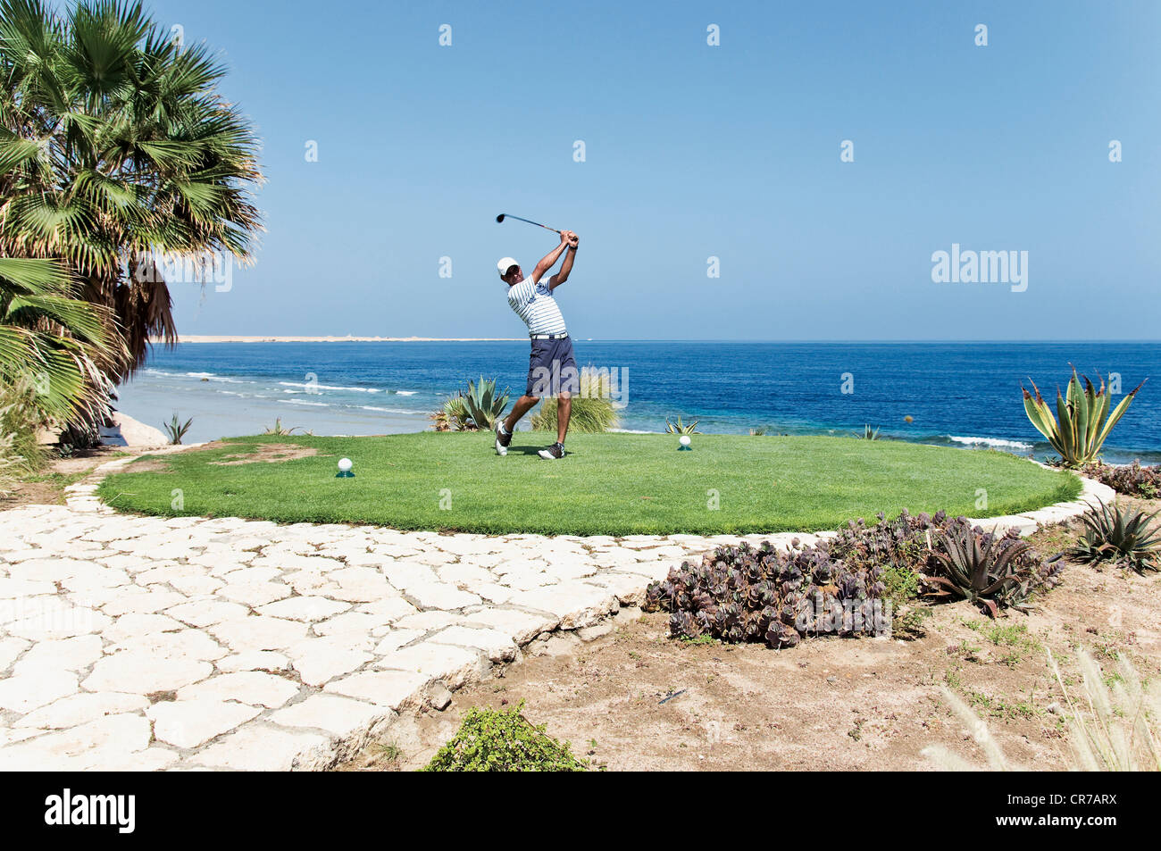 Egypt, Man playing golf on golf course Stock Photo