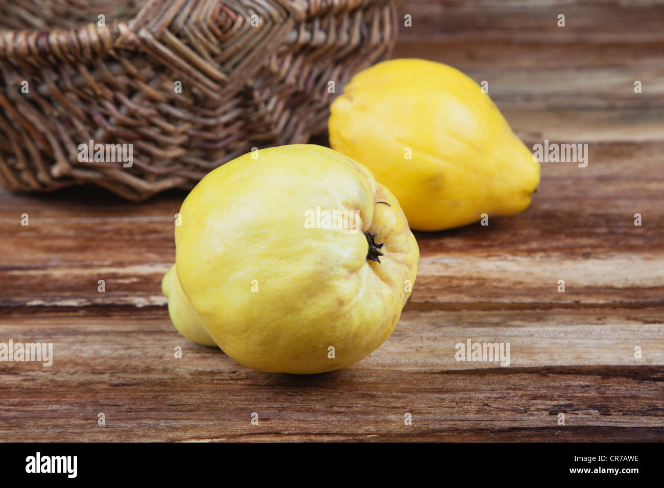 Quince on wooden table, close up Stock Photo