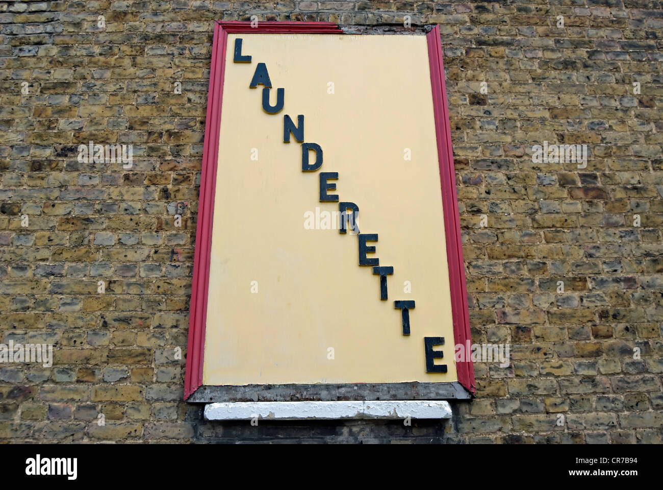 wall sign for a launderette, surbiton, surrey, england Stock Photo Alamy