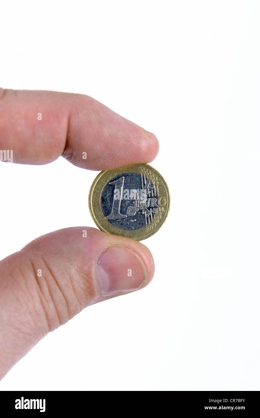 Fingers of one hand holding a 1 Euro coin Stock Photo
